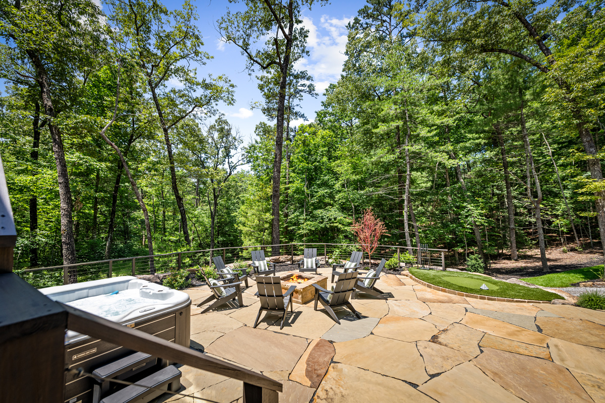 The private hot tub and fire pit on the deck after dark