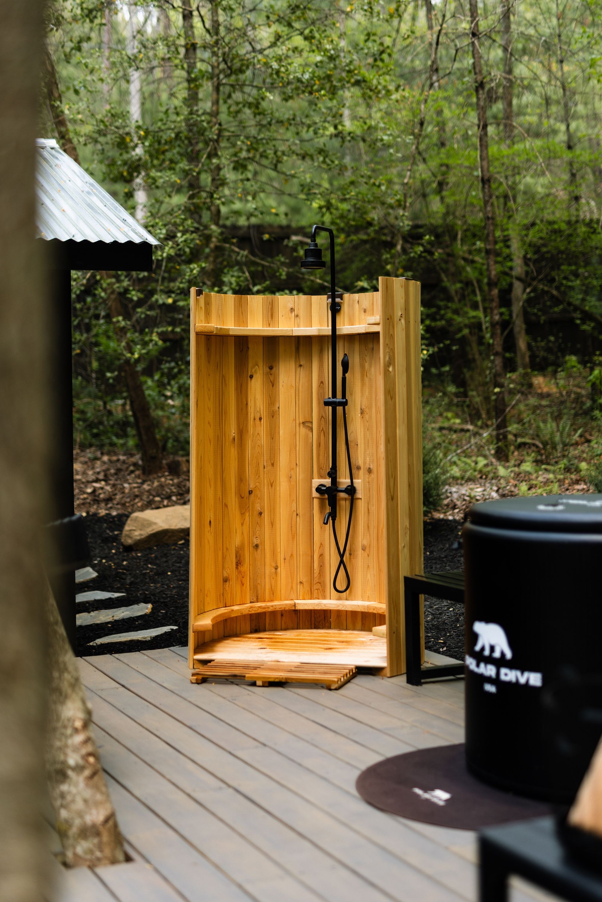 The barrel shower and cold plunge on the cedar deck