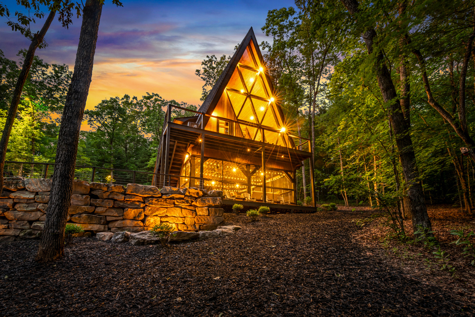 The Big Luxe A-frame lit from within at night