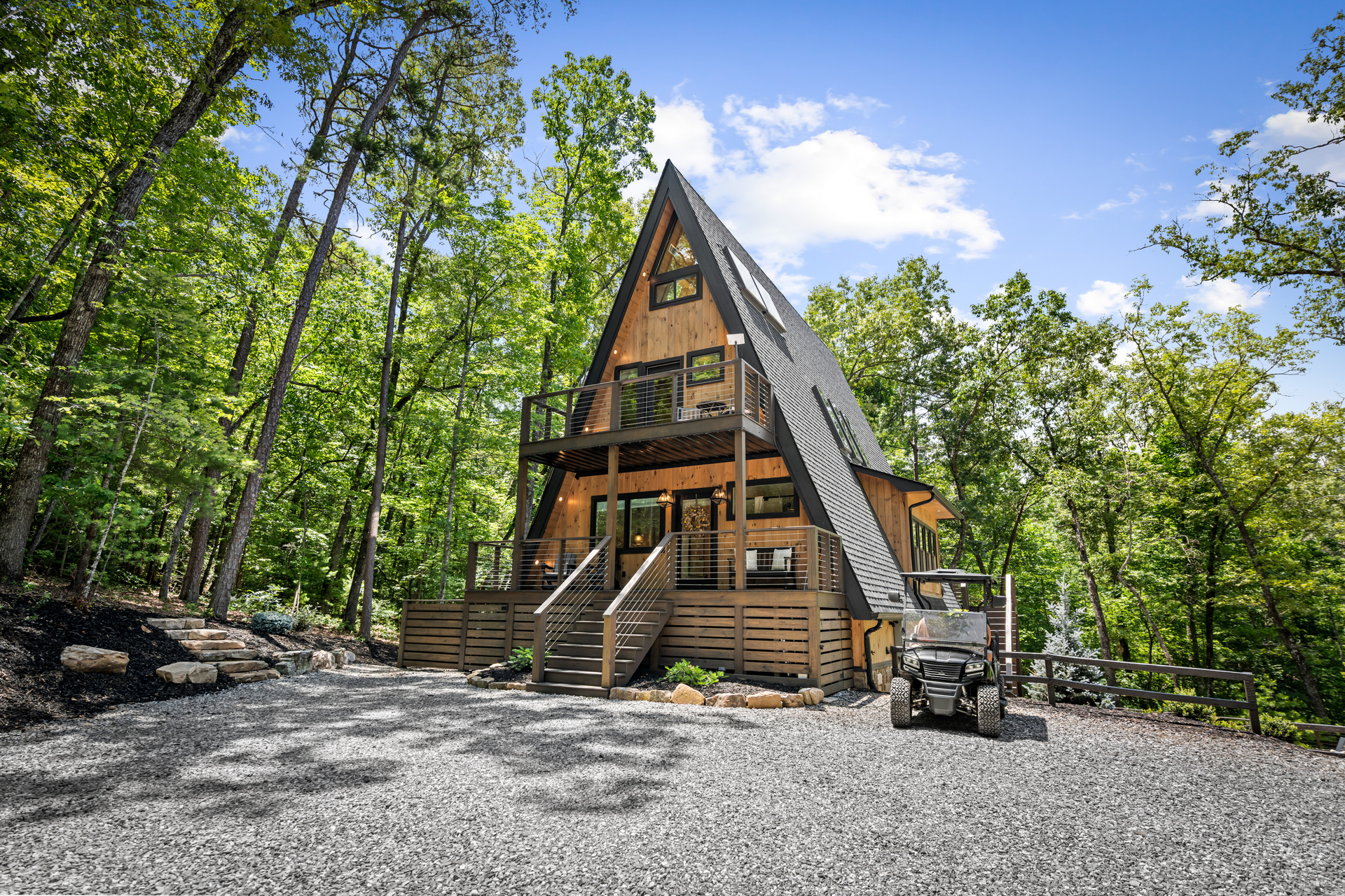 The Big Luxe A-frame and deck seen through the trees